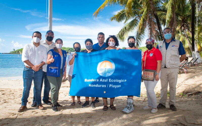 team poses with the new blue flag that half moon bay received for clean water