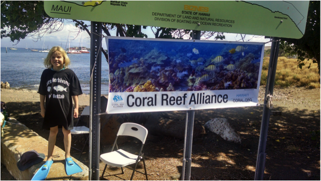 A young snorkeler sports a new KHFMA t-shirt after learning about the importance of herbivores at a recent CORAL outreach event for fishermen at the Mala Warf in Lahaina.
